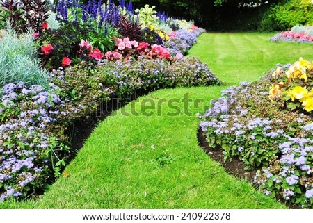 Grass Pathway and Flowerbed in a Beautiful Landscaped Garden