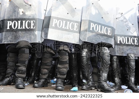 BANGKOK - NOV 24: Riot police stand guard during a violent anti government rally in the Thai capital on Nov 24, 2012 in Bangkok, Thailand. Protesters and police clashed repeatedly with dozens injured.