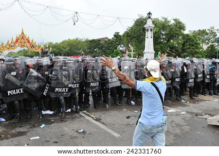 BANGKOK - NOV 24: An anti government protester confronts riot police during a violent rally on Nov 24, 2012 in Bangkok, Thailand. The protesters call for the government to be overthrown.