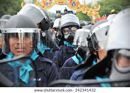 BANGKOK - NOV 24: A riot police officer stand guard during a city centre anti government rally on Nov 24, 2012 in Bangkok, Thailand. Police fired tear gas on several occassions to deter protesters.