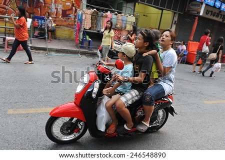 BANGKOK - APR 12: An unidentified family of four travel by motorbike on a city centre road on Apr 12, 2013 in Bangkok, Thailand. Road safety laws are often ignored and unenforced in the Thai capital.