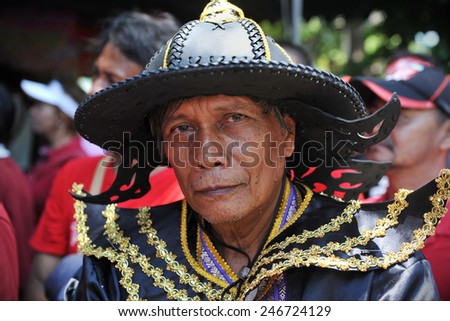 BANGKOK - MAY 8: A man wears traditional Thai military attire while attending Red Shirt rally on May 8, 2013 in Bangkok, Thailand. Protesters demand constitutional judges resign over alleged bias.