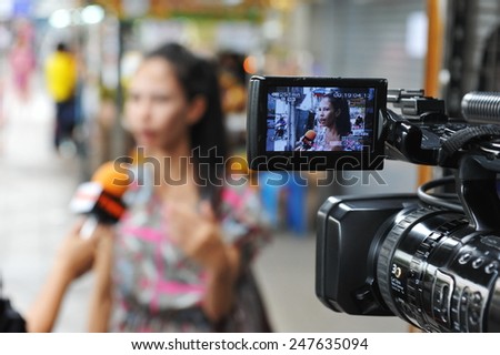 BANGKOK - MAY 27: A bystander gives an interview to news media after a nail bomb blast on May 27, 2013 in Bangkok, Thailand. The bomb injured 7 people, while police unclear of a motive or suspects.