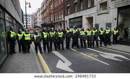 LONDON - MAR 26: Riot police block a road after violent riots break out in the city centre during a 250,000 strong TUC organised anti public sector spending cuts rally on Mar 26, 2011 in London, UK.
