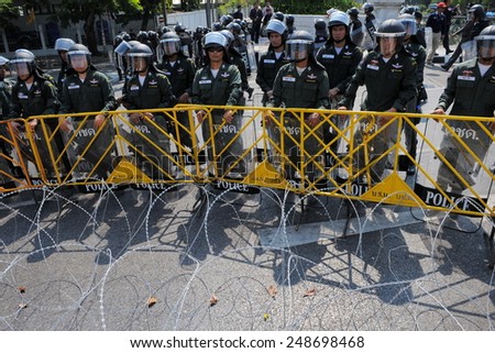 BANGKOK - FEB 11: Riot police stand guard at Government House during a protest on Feb 7, 2011 in Bangkok, Thailand. Royalist Yellow Shirt protesters gathered in opposition to upcoming elections.