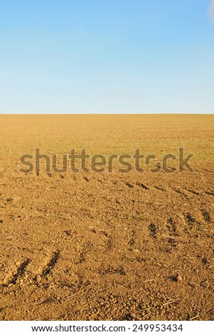Scenic View of Bare Earth on a Farmland Field