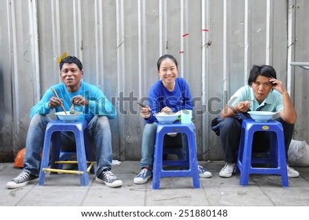 BANGKOK - JAN 13: Construction workers dine at a street-side restaurant on Jan 13, 2011 in Bangkok, Thailand. The Thai capital is undergoing a property boom with numerous construction projects.