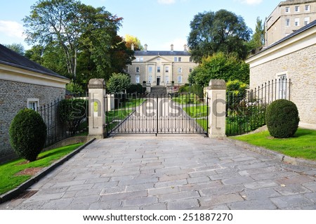 View of a Driveway and Gated Entrance of Old English Residential Buildings