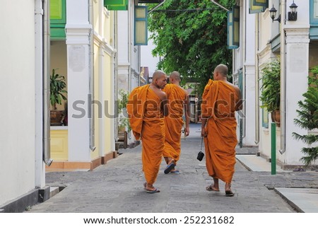 BANGKOK - JAN 20: Buddhist monks walk through the grounds of a city centre temple on Jan 20, 2011 in Bangkok, Thailand. There are an estimated 460,000 ordained monks in the Kingdom of Thailand.