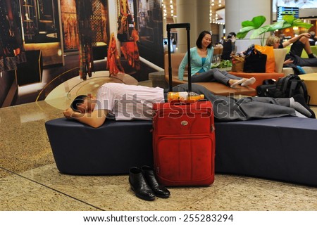 MUMBAI - APR 14: Travellers rest in the transit lounge at the new terminal T2 of Chhatrapati Shivaji International Airport on Apr 14, 2014 in Mumbai, India. The airport first opened in 1942.
