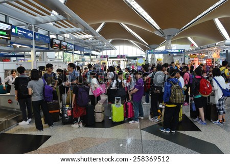 KUALA LUMPUR - MAR 2: Travellers queue to check-in at Kuala Lumpur International Airport (KLIA) on Mar 2, 2014 in Kuala Lumpur, Malaysia. KLIA has the capacity to carry 70 million passengers per year.