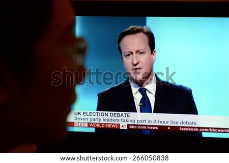 LONDON - APR 4:  A viewer watches Conservative Party PM David Cameron on an election TV debate on Apr 4, 2015 in London, UK. Major political parties joined the live TV debate ahead of polls on May 7.