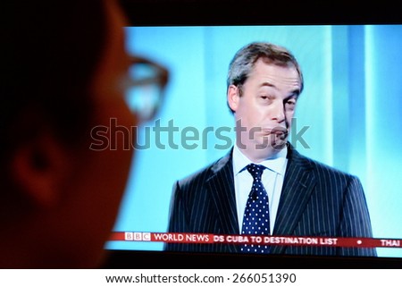 LONDON - APR 4:  A viewer watches UKIP leader Nigel Farage on an election TV debate on Apr 4, 2015 in London, UK. Major political parties joined the live TV debate ahead of polls on May 7.