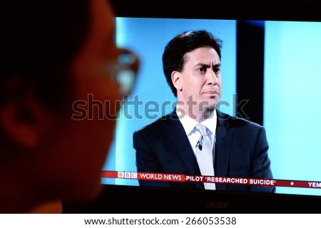 LONDON - APR 4:  A viewer watches opposition party Labour leader Ed Miliband on an election TV debate on Apr 4, 2015 in London, UK. Political parties joined the live TV debate ahead of polls on May 7.