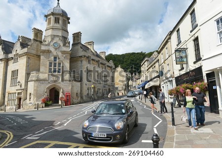 BRADFORD ON AVON - AUG 17: Street view of people and cars in the old town centre on Aug 17, 2014 in Bradford on Avon, UK. The picturesque Wiltshire town is a popular tourist destination.