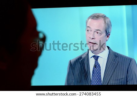 LONDON - APR 4: A viewer watches UKIP leader Nigel Farage on an election TV debate on Apr 4, 2015 in London, UK. Major political parties joined the live TV debate ahead of polls on May 7.