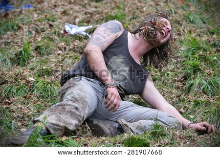 BROCKWORTH - MAY 25: A reveller joins the traditional cheese rolling races on May 25, 2015 in Brockworth, UK. Thousands attended the unofficial annual event which dates back to at least 19th century.