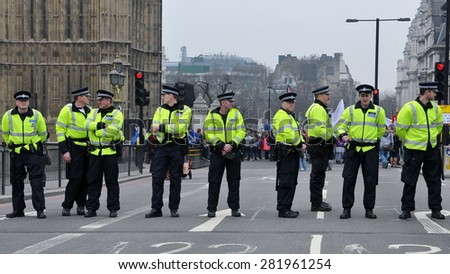 LONDON - MAR 26: Riot police stand guard at Westminster Palace road block as violent riots break out in the city centre during anti austerity rally on Mar 26, 2011 in London, UK.