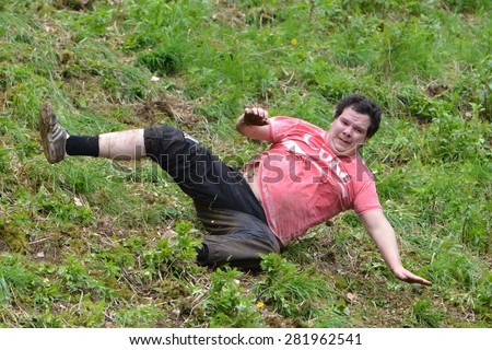BROCKWORTH - MAY 25: A reveller joins the traditional cheese rolling races on May 25, 2015 in Brockworth, UK. Thousands attended the unofficial annual event which dates back to at least 19th century.