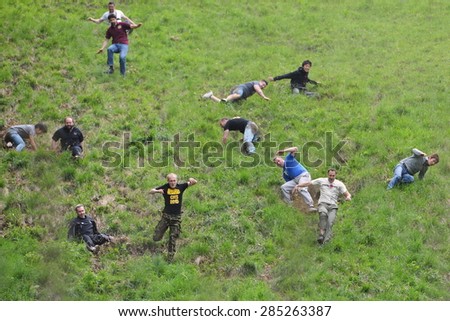 BROCKWORTH - MAY 25: Revellers join the traditional cheese rolling races on May 25, 2015 in Brockworth, UK. Thousands attended unofficial annual event which dates back to at least 19th century.