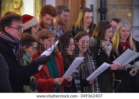 BATH - DEC 9: People sing carols at the Christmas Market in the streets surrounding Bath Abbey on Dec 9, 2015 in Bath, UK. The market is held annually in the historic Unesco World Heritage City.