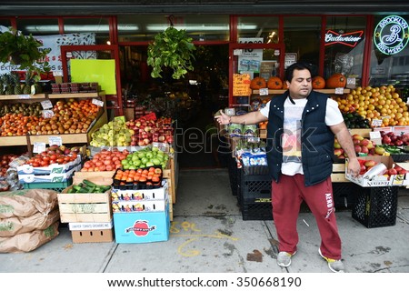 NEW YORK CITY - NOV 11: A man sell fruit at a supermarket store in Queens on Nov 11, 2015 in New York City, USA.