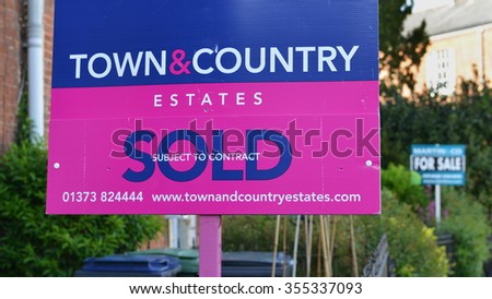 WESTBURY, UK - MAY 20, 2015: View of estate agency sold sign on a town centre street. The UK is experiencing a consistent increase in house prices leaving many unable to get on the property ladder.