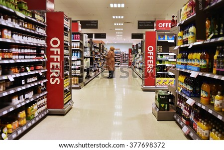 BATH, UK - FEB 10, 2015: Aisle view in a Waitrose supermarket. Founded in 1904 Waitrose is the food retail division of the John Lewis Partnership, Britain\'s largest employee owned retailer.