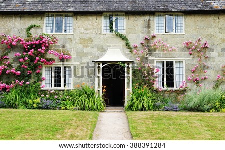 Exterior View and Garden Lawn of a Picturesque Old Rural English Cottage