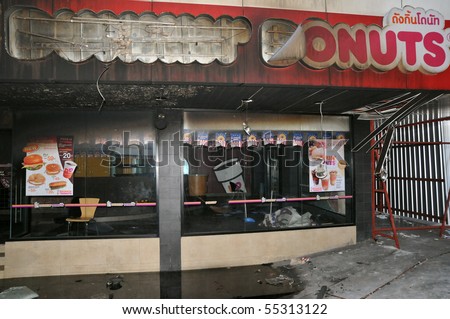 BANGKOK - MAY 23: Fire damaged exterior of a Dunkin\' Donuts shop in the aftermath of the anti government \'Red Shirt\' protest May 23, 2010 in Bangkok, Thailand