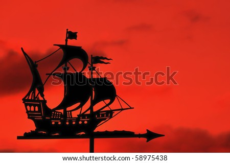 stock photo : Silhouette of Ship Weather Vane against a Red Sky at Sunset