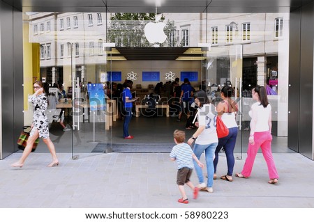 LONDON - JULY 28: Shoppers enter an Apple store as major retail group DSG International predict the electronics giant\'s iPad will become a Christmas best seller July 28, 2010 in London, UK.