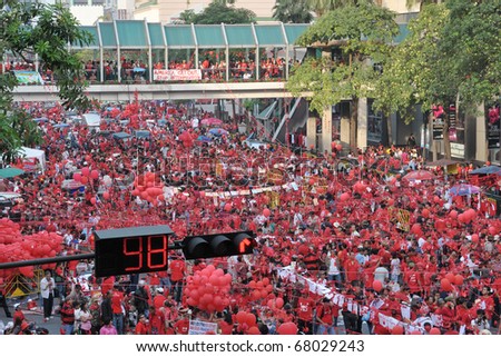 BANGKOK - DECEMBER 19: An estimated 10,000 anti government Red Shirts defy an emergency decree to protest at Rachaprasong junction on December 19, 2010 in Bangkok, Thailand.