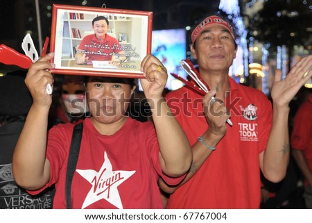 BANGKOK - DECEMBER 19: Red Shirts at a protest at Rachaprasong display an image of Thaksin Shinawatra, former PM of Thailand who was ousted in a 2006 coup on December 19, 2010 in Bangkok, Thailand.
