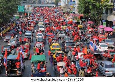 BANGKOK - JANUARY 23: Thousands of anti- government Red Shirt protesters leave Ratchaprasong Junction en route to a rally site at Democracy Monument on January 23, 2011 in Bangkok, Thailand.
