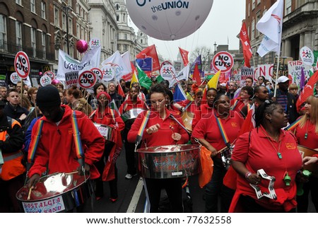 LONDON - MARCH 26: A steel band plays as protesters march against spending cuts to the public sector March 26 2011, in London, UK. An estimated 250,000 people attended the TUC organised rally.