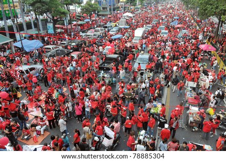 BANGKOK - DECEMBER 19: Thousands of anti-government red-shirt protesters defy an emergency decree to rally at Ratchaprasong Junction on December 19, 2010 in Bangkok, Thailand.