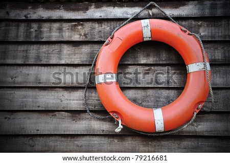 Life Buoy attached to a Wooden Paneled Wall with Plenty of Copy Space