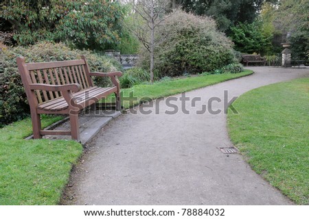 Wooden Bench and Winding Path in a Tranquil Garden