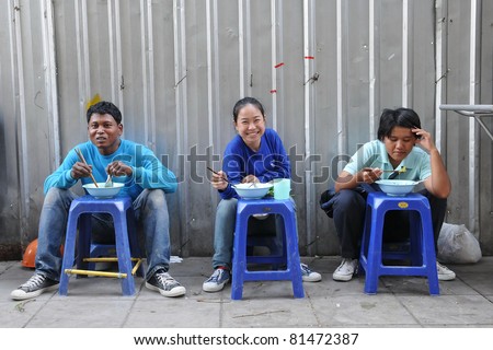 BANGKOK - JAN 13: Unidentified construction workers have their meal on Jan 13, 2011 in Bangkok, Thailand. Bangkok is currently undergoing a property boom with numerous construction projects.