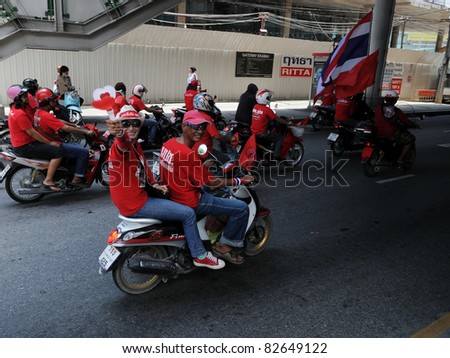 BANGKOK - MAY 19: A convoy of red-shirt protesters ride to Ratchaprasong on May 19, 2011 in Bangkok, Thailand. The red-shirts gathered to mark one year since 91 people died in protests in the capital.
