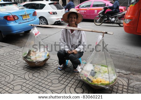 BANGKOK - AUG 16: An unidentified street vendor sells deserts on Aug 16, 2011 in Bangkok, Thailand. There are more than 16,000 registered street vendors in Bangkok.