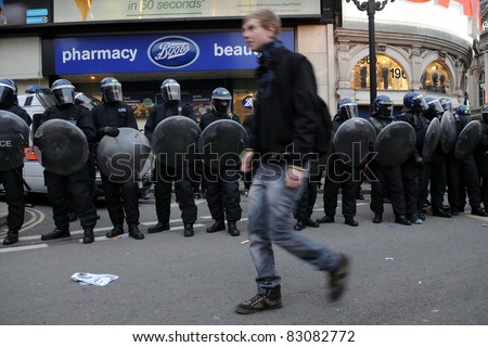 LONDON - MARCH 26: Police in riot gear on standby at Piccadilly Circus in central London during a large anti-cuts rally on March 26, 2011 in London, UK.