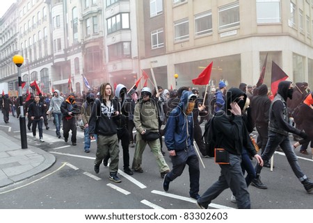 LONDON - MARCH 26: A breakaway group of protesters march through the streets of the British capital during a large anti-cuts rally on 26 March 2011 in London, UK.