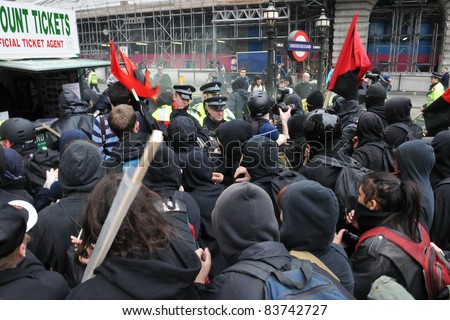 LONDON - MARCH 26: Anti-cuts protesters push through police lines on Picaddilly during a large anti-cuts rally on March 26, 2011 in London, UK.