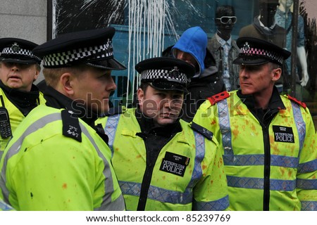 LONDON - MARCH 26: Policemen on duty in central London after having come under attack by a breakaway group of protesters during a large anti-cuts rally on March 26, 2011 in London, UK.