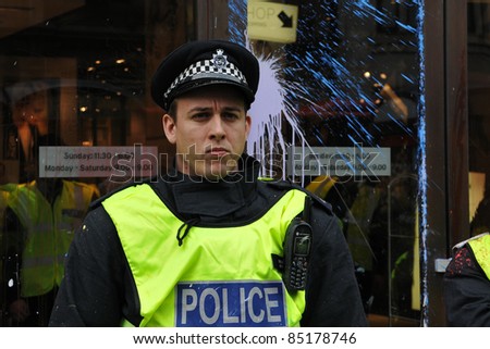 LONDON - MARCH 26: Policeman on duty in central London after having come under attack by a breakaway group of protesters during a large anti-cuts rally on March 26, 2011 in London, UK.