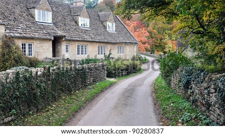 Row of Old Stone Cottages on a Country Road in Rural England