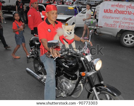 BANGKOK - FEB 13: A red-shirt protester and his dog on a motorbike at a large anti-government rally at Democracy Monument on Feb 13, 2011 in Bangkok, Thailand.