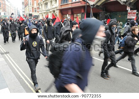 LONDON - MARCH 26: A breakaway group of protesters march through the streets of the British capital during a large anti-cuts rally on March 26, 2011 in London, UK.